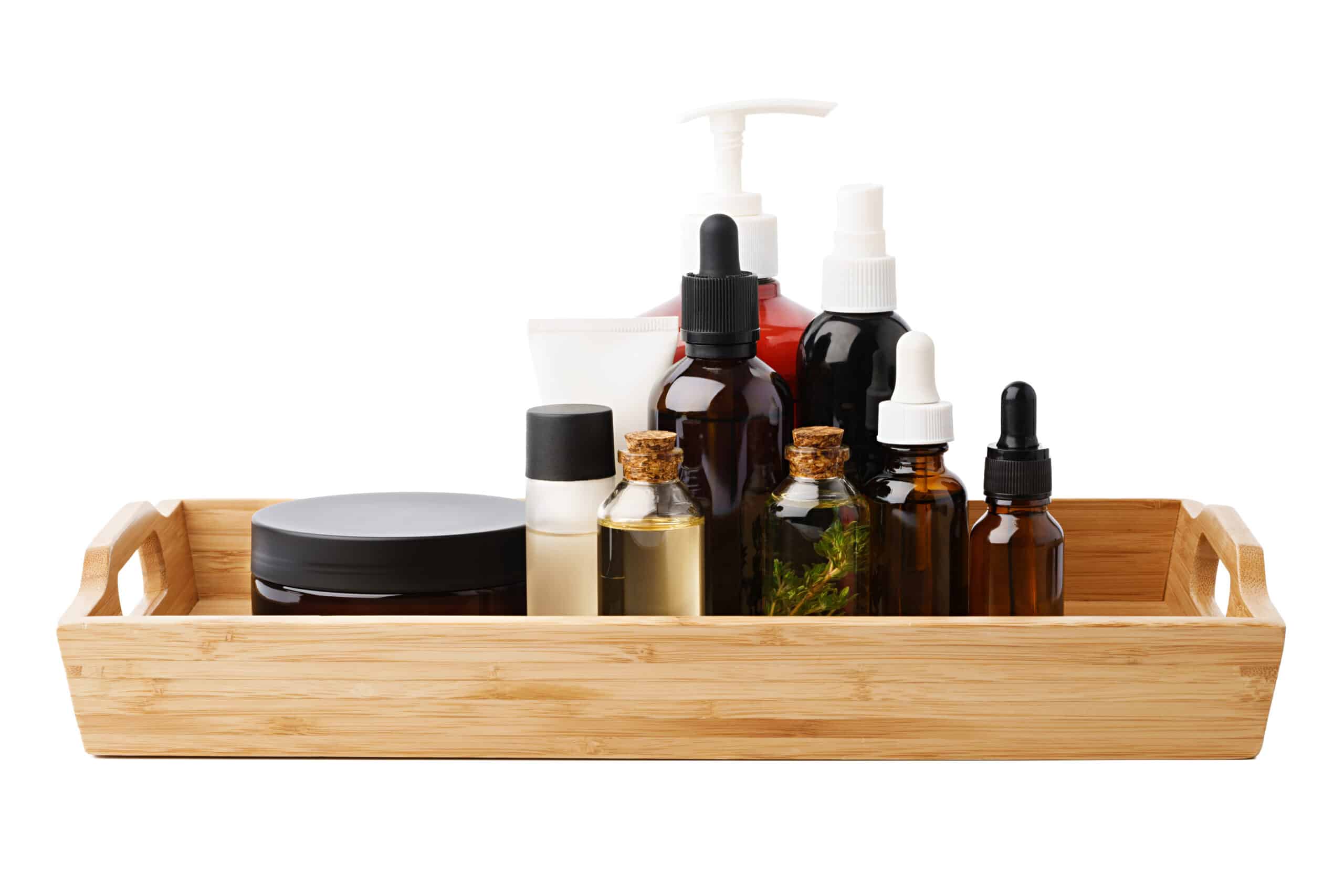 Set of cosmetic dark glass bottles on wooden stand