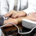 The female doctor measured blood pressure, the patient examined the heartbeat and sat down to talk about health care closely. health care concept.