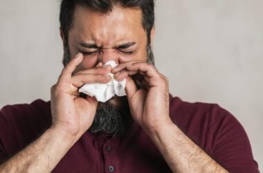 Sick Indian man blowing his nose