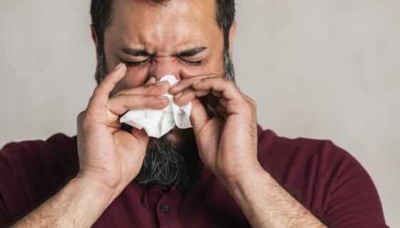 Sick Indian man blowing his nose